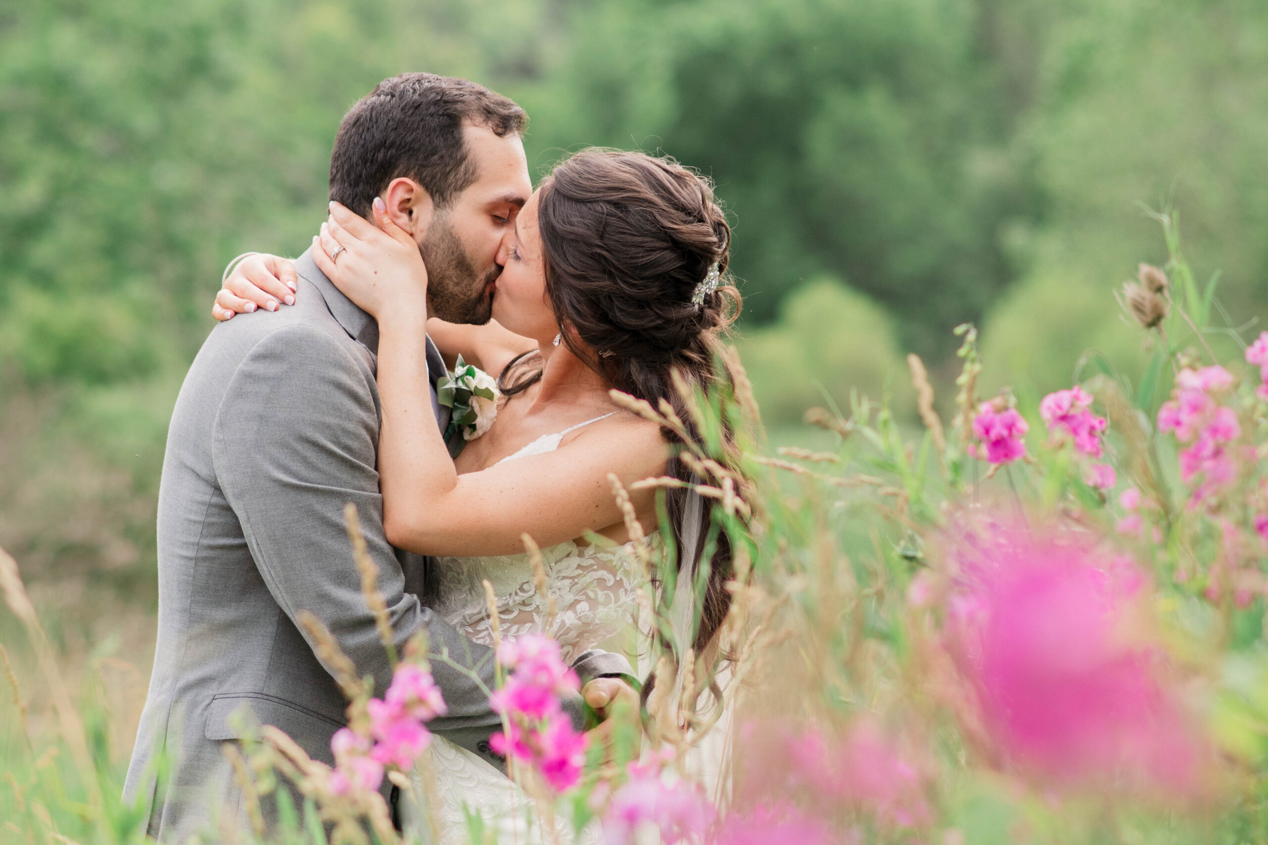 Wedding Photos in Altoona PA, Couple among tall grasses with purple flowers.
